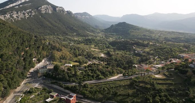 Beautiful Village Surrounded By Mountain Landscape At Sunrise In Sardinia, Italy. Aerial Shot.