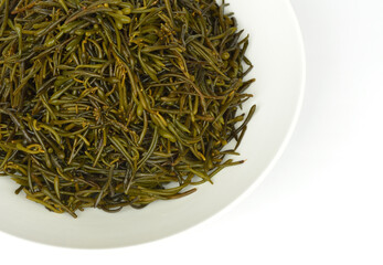 Close-up and top angle view of stacked wet raw seaweed of hizikia fusiforme on white dish, South Korea
