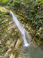 Waterfall on a mountain river in nature. In summer