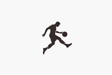 Dark silhouette of a soccer player in mid-action, jumping and kicking a soccer ball. The player's figure is outlined clearly, emphasizing movement, agility, and strength.