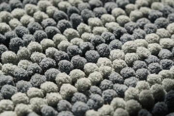 Closeup navy and grey color fluffy doormat with fur of pet in sunlight. Cleaning and hygiene house concept. Surface and texture background.