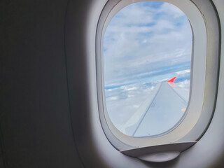 Fototapeta premium travel and transportation concept with see city and beautiful sky from airplane window