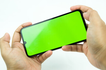 Phone in hand with green screen. isolated on white