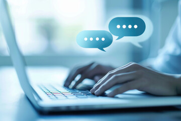 Person typing on their laptop with two speech bubbles above the keyboard indicating an online conversation.