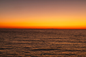 Sunset Serenity,Beautiful Horizon of Orange Sky and Reflective Waters