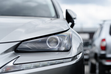 car headlight, close up view, car dealing and manufacturing, cropped car image