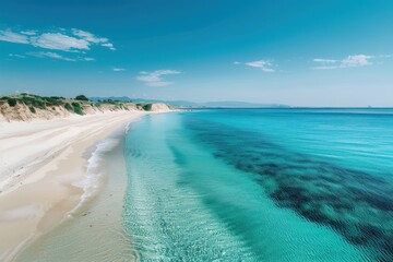 Fototapeta premium Tranquil Coastal Scene with Sandy Beach and Clear Turquoise Water