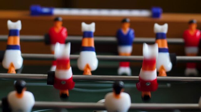 close up of indoor table football playing field, players compete in table football game. home family table sports games