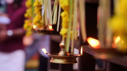 Traditional south indian brass oil lamp Nilavilakku .  Nilavilakku is lighted before starting the rituals This picture is taken during Kerala traditional ulsavam