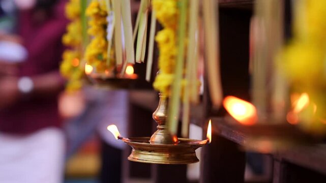 Traditional south indian brass oil lamp Nilavilakku .  Nilavilakku is lighted before starting the rituals This picture is taken during Kerala traditional ulsavam