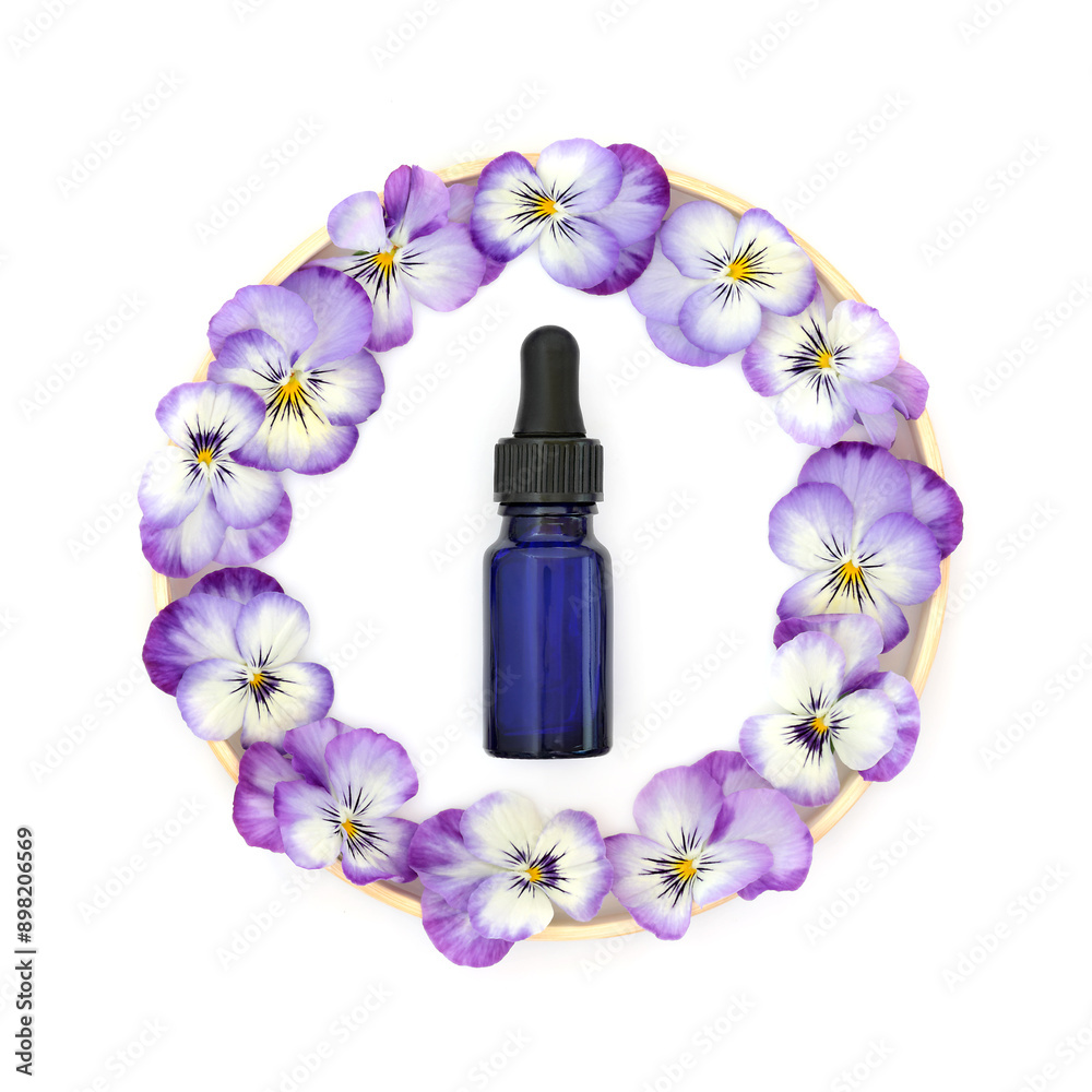 Wall mural pansy flower wreath, blue aromatherapy essential oil bottle on white with wooden frame. floral essen