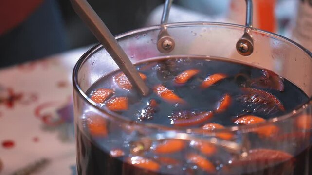 Beverages berries hot mulled wine in pots street food market at Christmas time. festive hot drinks at fair christmas festival outdoors close-up drinks fruits and berries hot mulled wine in pots