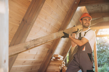 Process of construction new and modern modular house. Worker man in special protective uniform wear...