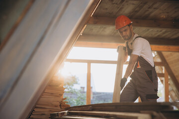 Process of construction new and modern modular house. Worker man in special protective uniform wear working on building development industry of energy efficient property.