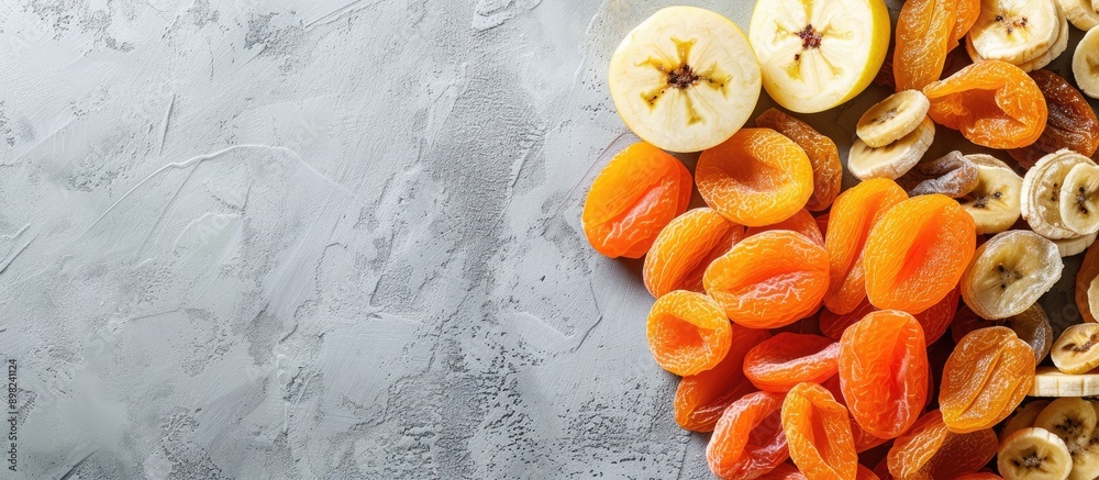 Aufkleber Assorted dried fruits like bananas apples and apricots arranged for a flat lay view creating a space for text with a copy space image