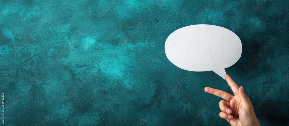 Poster Close up photo of a hand holding an empty white speech bubble for a text message with a copy space image