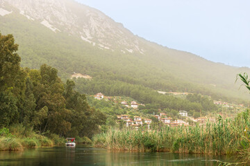Fototapeta premium Hazy morning by the river at a small charming town of Akyaka in Mula Province, Turkey.