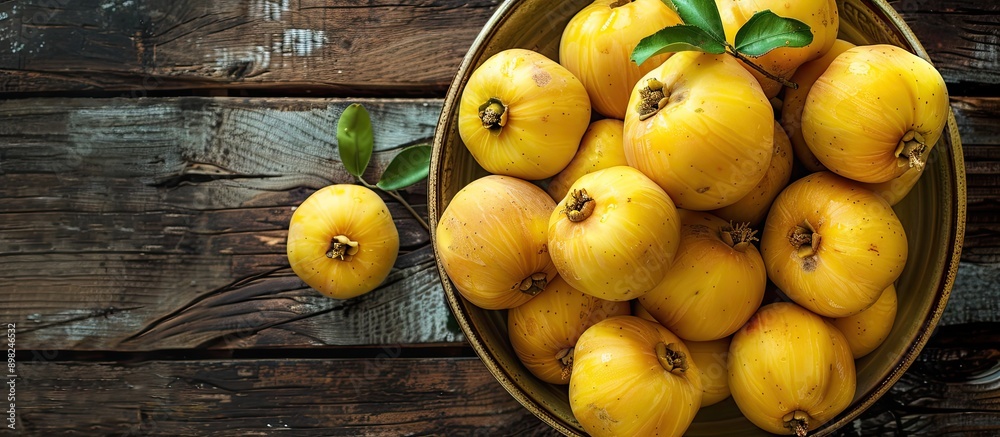 Canvas Prints close up of delicious ripe quinces in a bowl on a wooden table with copy space image available