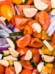 Tomatoes, Red Onions, Yellow Peppers and Courgettes ready for a oven tray bake
