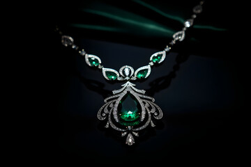 Luxurious White Gold Link Necklace with Exquisite Emeralds Illuminating Against Black Background