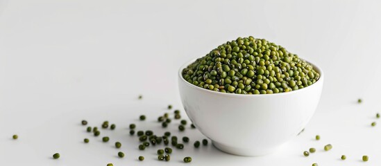 A bowl filled with mung beans or green gram seeds on a white backdrop ideal for a copy space image
