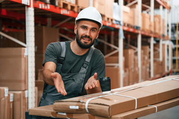 Showing packages by hand. Foreman is in the storehouse, shipping distribution business