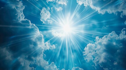 Sun is shining in the cloudy blue sky. Radial sun light rays on blue sky background.