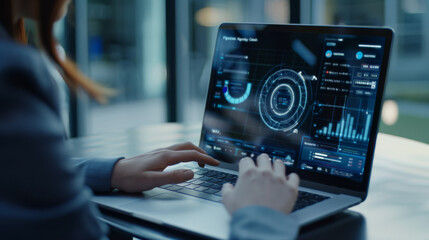 A person working on a high-tech laptop displaying futuristic data and analytics in a sleek, tech-focused environment.