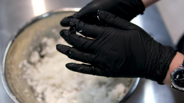 Cooking coconut balls Close up chef hands cooking Coconut Balls or Ka Nom Tom, Thai Traditional Dessert