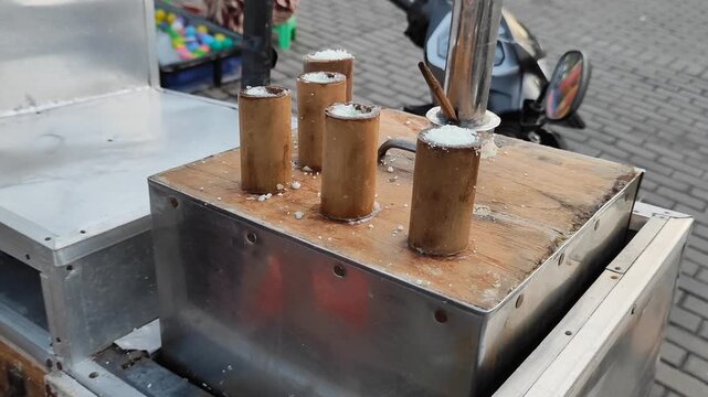 Mans hand cooking putu cake (kue putu). Indonesian traditional cake