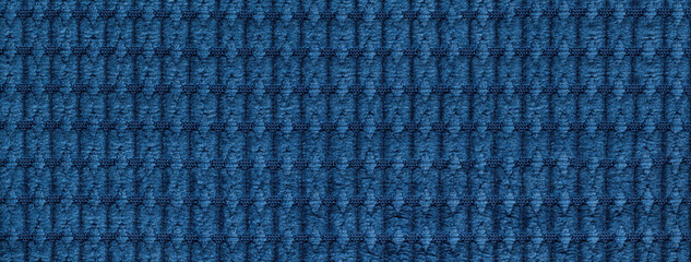 Texture of navy blue and denim fabric background with rhomboid pattern, macro. Abstract sapphire backdrop