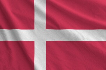 Fototapeta premium Denmark flag depicted on folded wavy fabric of old cloth close up