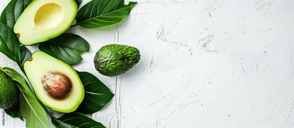 Poster Avocado placed on a white wooden table with a blank space for an image. Creative banner. Copyspace image