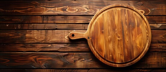 Fototapeta premium Circular cutting board on a vibrant wooden backdrop with ample copy space image