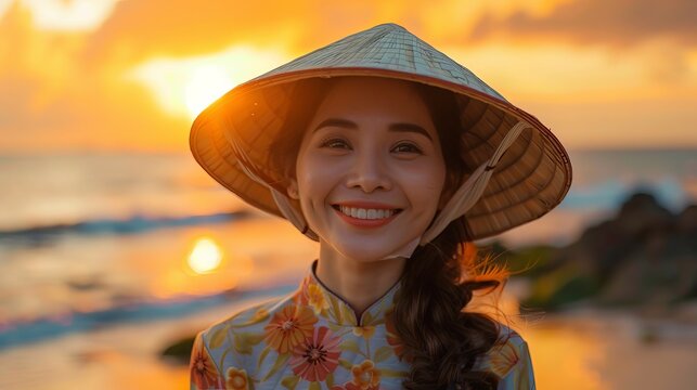 Adult Vietnamese Woman in Conical Hat and Ao Dai Standing Against Sunset