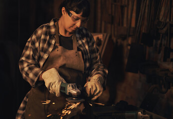 Small business, woman and welder in workshop for metal work, maintenance and crafting steel. Garage, blacksmith and empowerment with remodeling to repair objects for supply, welding and industrial