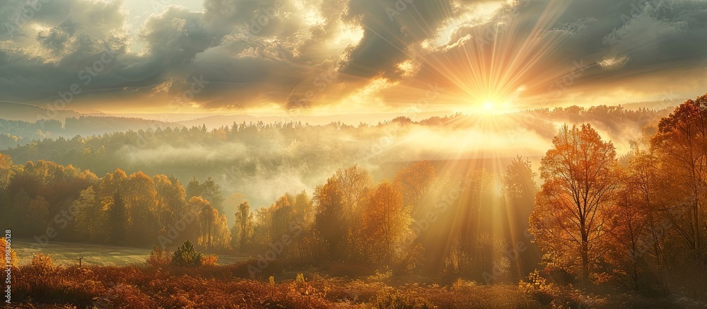 Poster cloudy autumn sunrise with sun rays filtering through creating a picturesque backdrop suitable for a