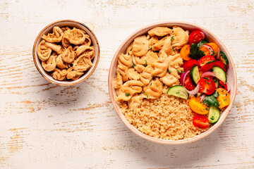 Bowl of quinoa with vegan soy meat and vegetables.