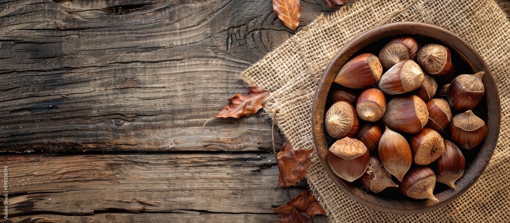 Aufkleber Chestnuts displayed on a rustic wooden table with a burlap napkin presenting a quaint setting for a copy space image