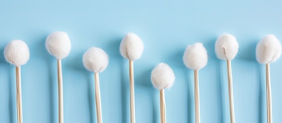 Cotton swabs placed in an orderly row with ample copy space image