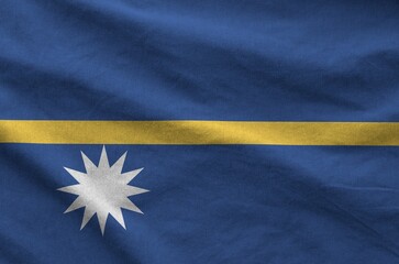 Nauru flag depicted on folded wavy fabric of old cloth close up