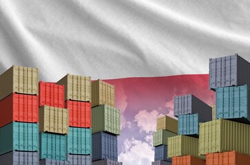 Poland flag and big stack of shipping cargo containers in docks with sky background close up