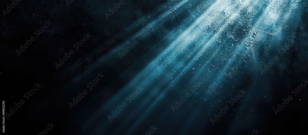 Aufkleber Dark backdrop featuring a focused beam of light contrasted with a lack of visual elements creating a copy space image