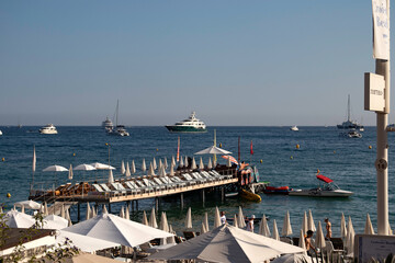 A jetty over the sea and yachts on the water at the beach on La Croisette in Cannes in the wouth of France