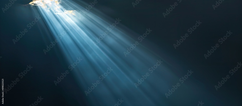 Aufkleber Dark backdrop featuring a focused beam of light contrasted with a lack of visual elements creating a copy space image