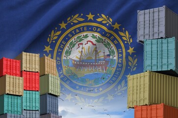 New Hampshire US state flag and big stack of shipping cargo containers in docks with sky background close up