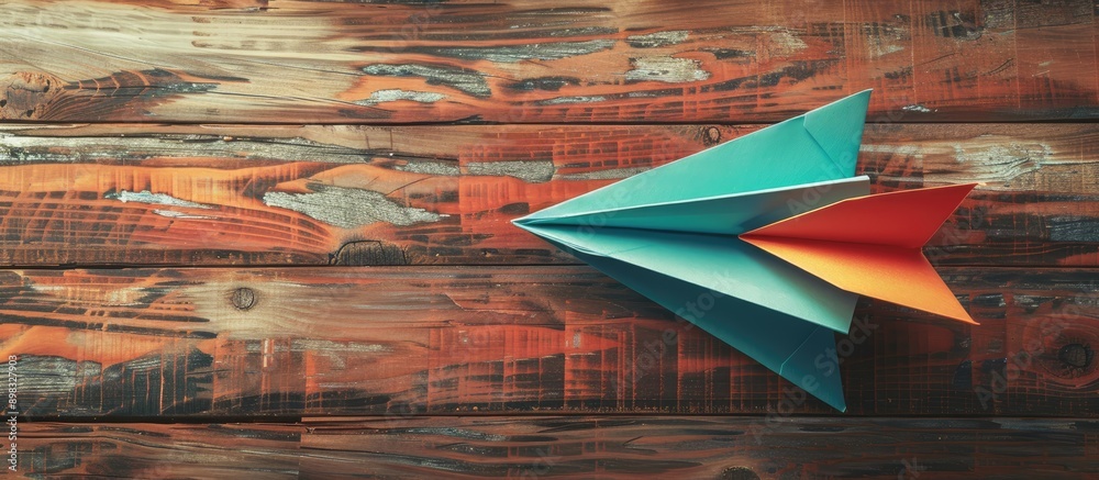 Aufkleber business competition concept depicted by a colorful paper plane on a wooden backdrop with copy space
