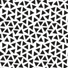 Triangular seamless pattern, a collection of scattered black triangles on a transparent background