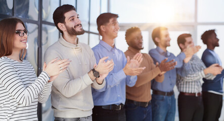 Fototapeta premium Close up side profile, different participants business people stand and express appreciation by clapping their hands