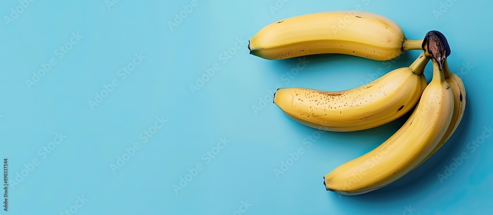 Poster a blue backdrop with bananas and copy space image